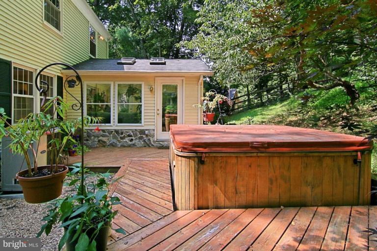 11412 Running Cedar Road Reston, VA 20191 - Photo 13 of 18 a view of a patio with table and chairs potted plants and large tree