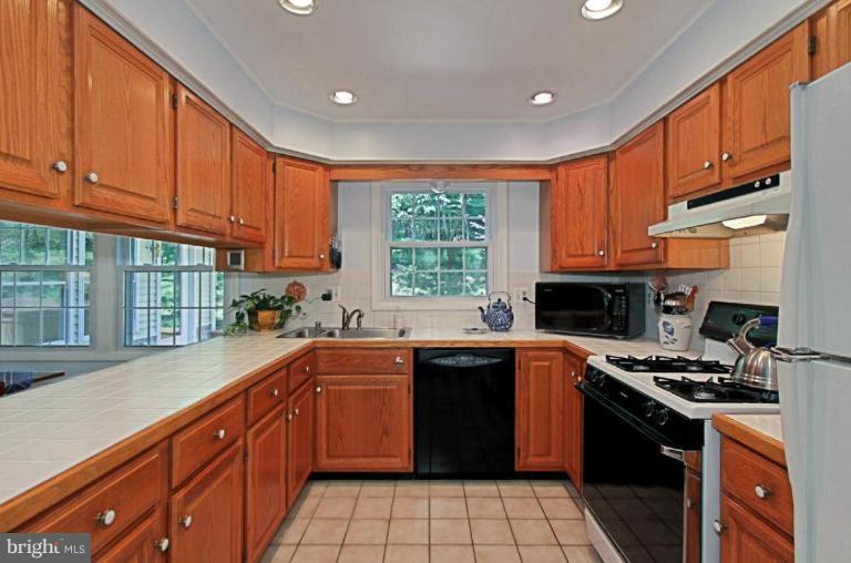 11412 Running Cedar Road Reston, VA 20191 - Photo 5 of 18 a kitchen with a sink stove top oven and cabinets