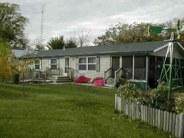 9209 West Wire Road Winslow, IL 61089 - Photo 1 of 9 a view of a house with backyard sitting area and garden