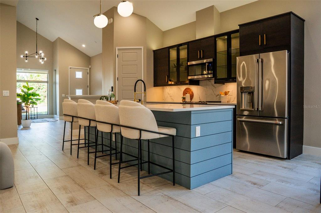2514 Shannon Road Orlando, FL 32806 - Photo 13 of 53 a kitchen with kitchen island a counter top space cabinets and stainless steel appliances
