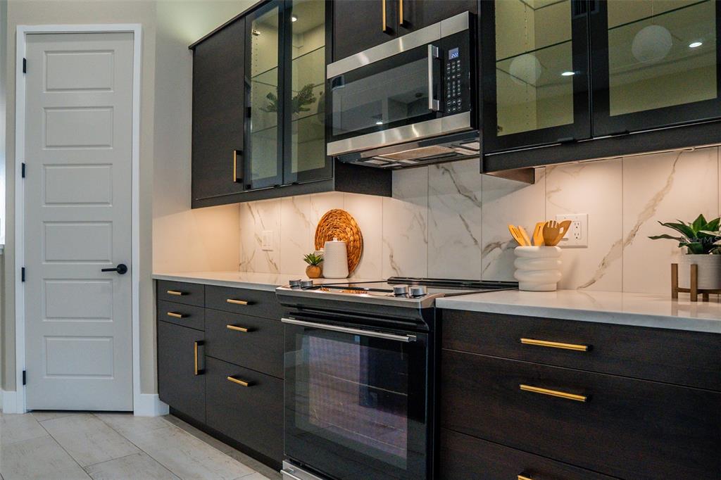 2514 Shannon Road Orlando, FL 32806 - Photo 8 of 53 a kitchen with a stove microwave and cabinets