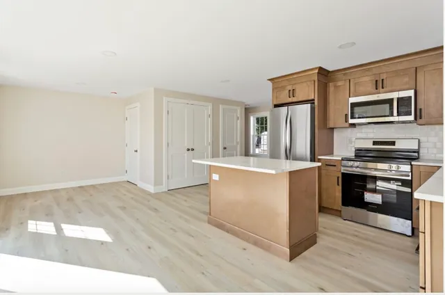a kitchen with stainless steel appliances a refrigerator and a sink