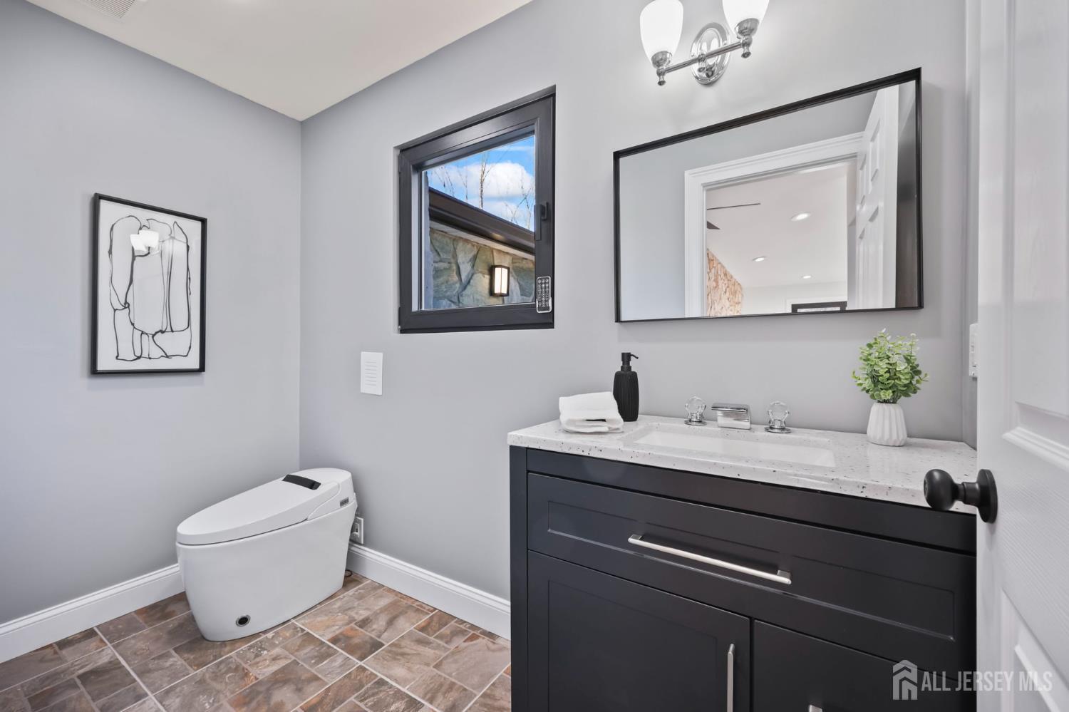 120 Nolan Road Morganville, NJ 07751 - Photo 20 of 85 a bathroom with a toilet a sink and mirror