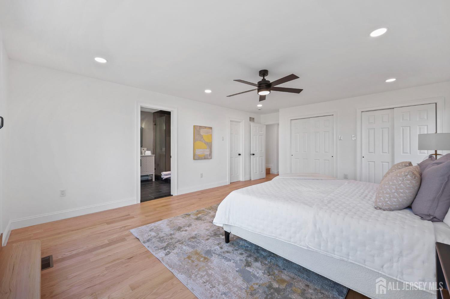 120 Nolan Road Morganville, NJ 07751 - Photo 23 of 85 a bedroom with a large bed and a ceiling fan