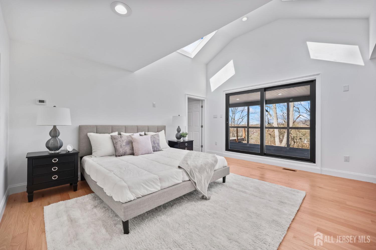 120 Nolan Road Morganville, NJ 07751 - Photo 29 of 85 a spacious bedroom with a large bed and a large window