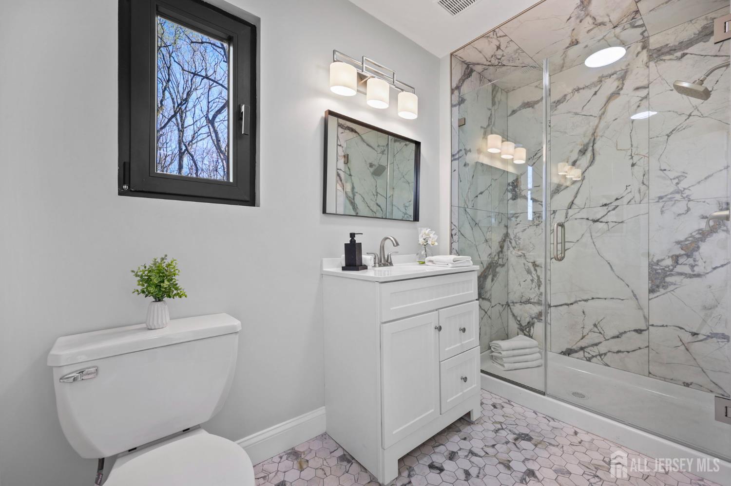 120 Nolan Road Morganville, NJ 07751 - Photo 30 of 85 a bathroom with a toilet sink and mirror