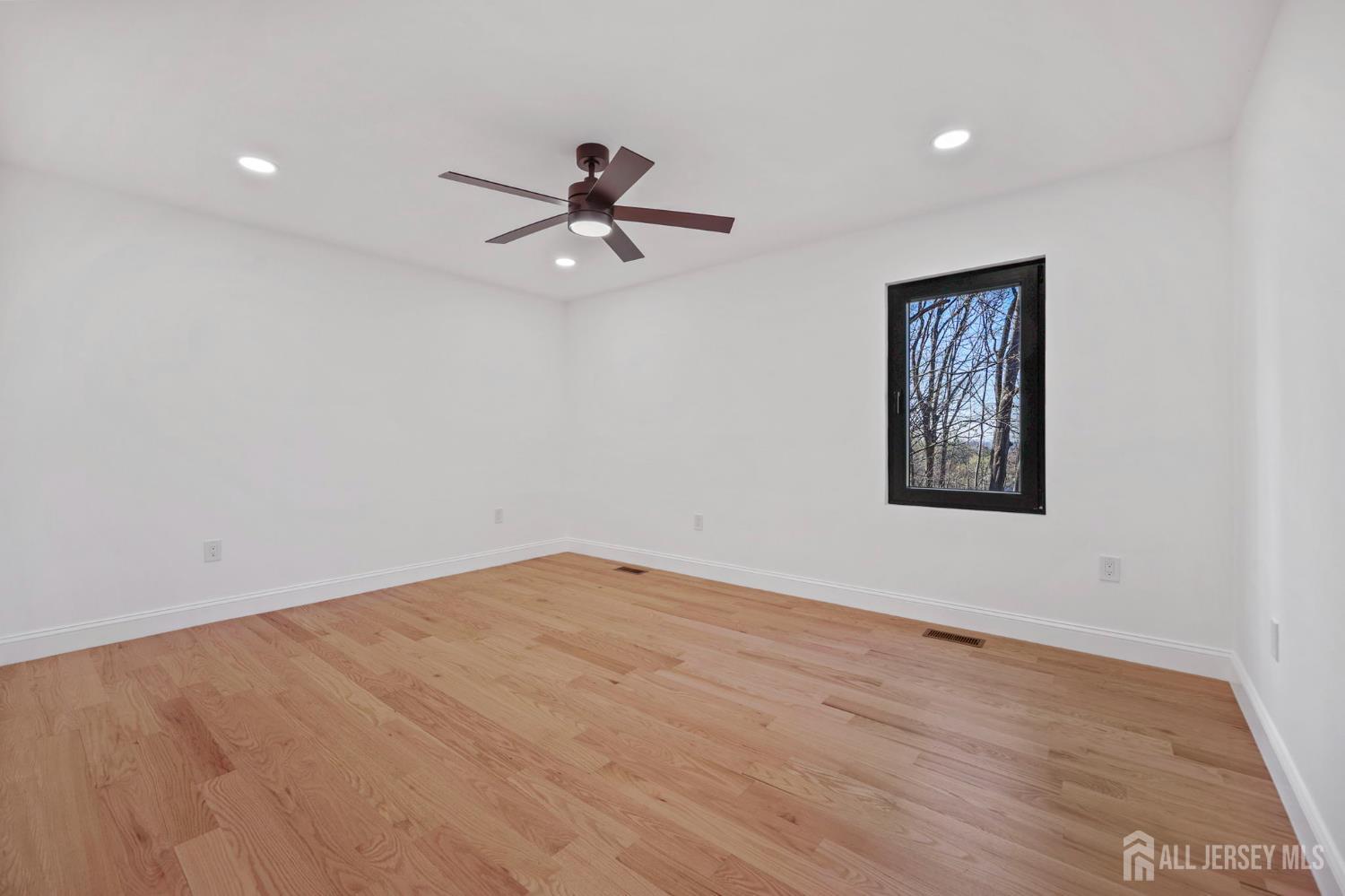 120 Nolan Road Morganville, NJ 07751 - Photo 39 of 85 a view of empty room with wooden floor