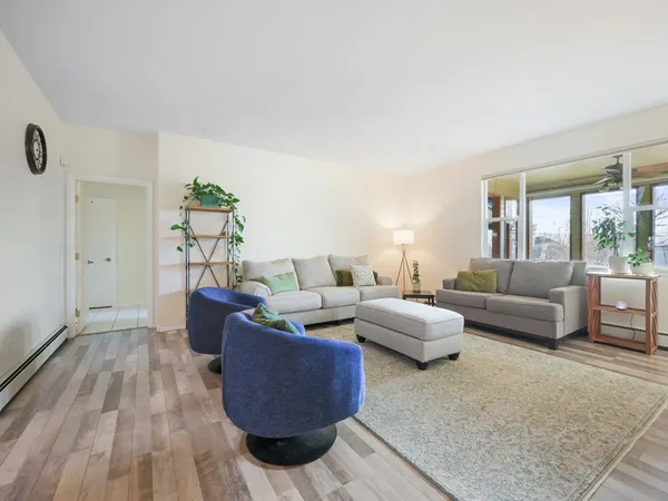 a living room with furniture and wooden floor