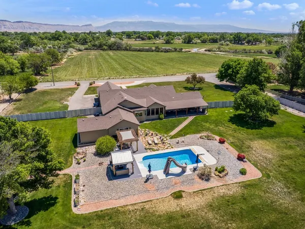 an aerial view of a house with yard swimming pool and outdoor seating