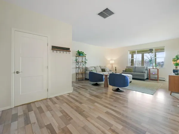 a view of a room with wooden floor
