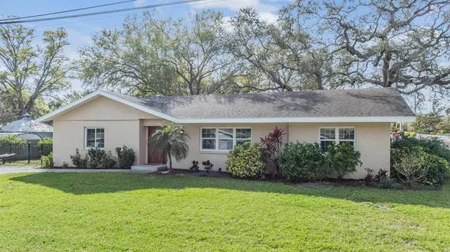 a front view of house with yard and green space