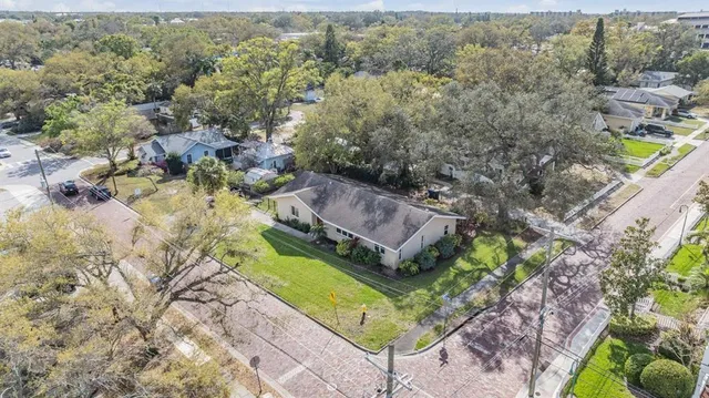 an aerial view of a house with a yard