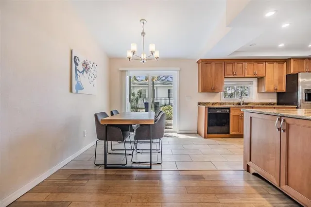 a kitchen with granite countertop a stove cabinets and wooden floor