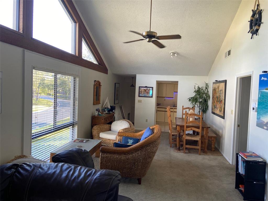 11450 Harbor Way, Unit 5002 Largo, FL 33774 - Photo 7 of 25 a living room with furniture and a large window