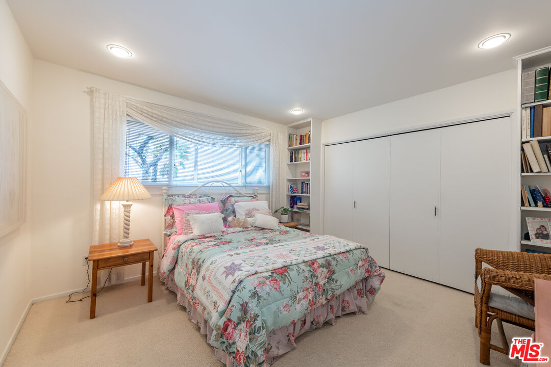 16331 Tudor Drive Encino, CA 91436 - Photo 29 of 71 a bedroom with a bed and a lamp on table