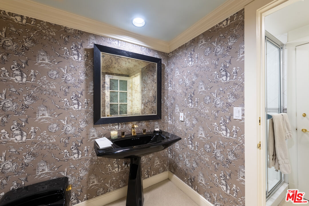 16331 Tudor Drive Encino, CA 91436 - Photo 30 of 71 a bathroom with a sink and a mirror