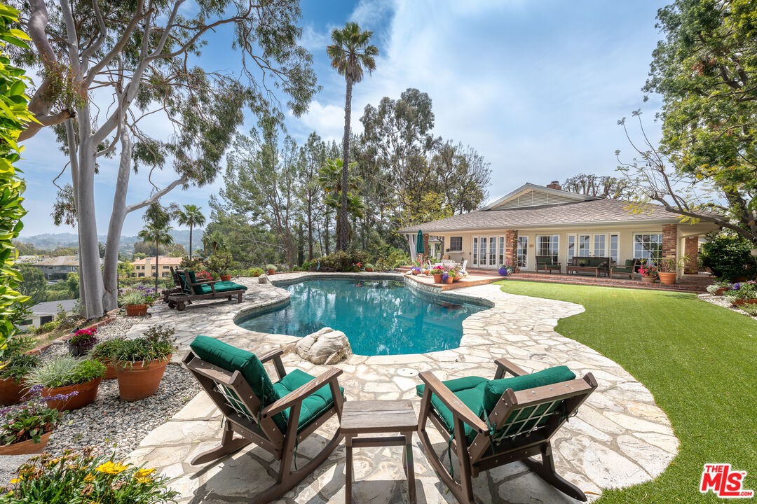 16331 Tudor Drive Encino, CA 91436 - Photo 38 of 71 a view of a house with swimming pool and couches chairs