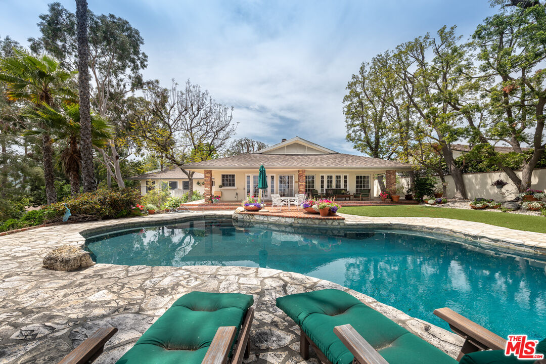 16331 Tudor Drive Encino, CA 91436 - Photo 39 of 71 a front view of a house with swimming pool having outdoor seating