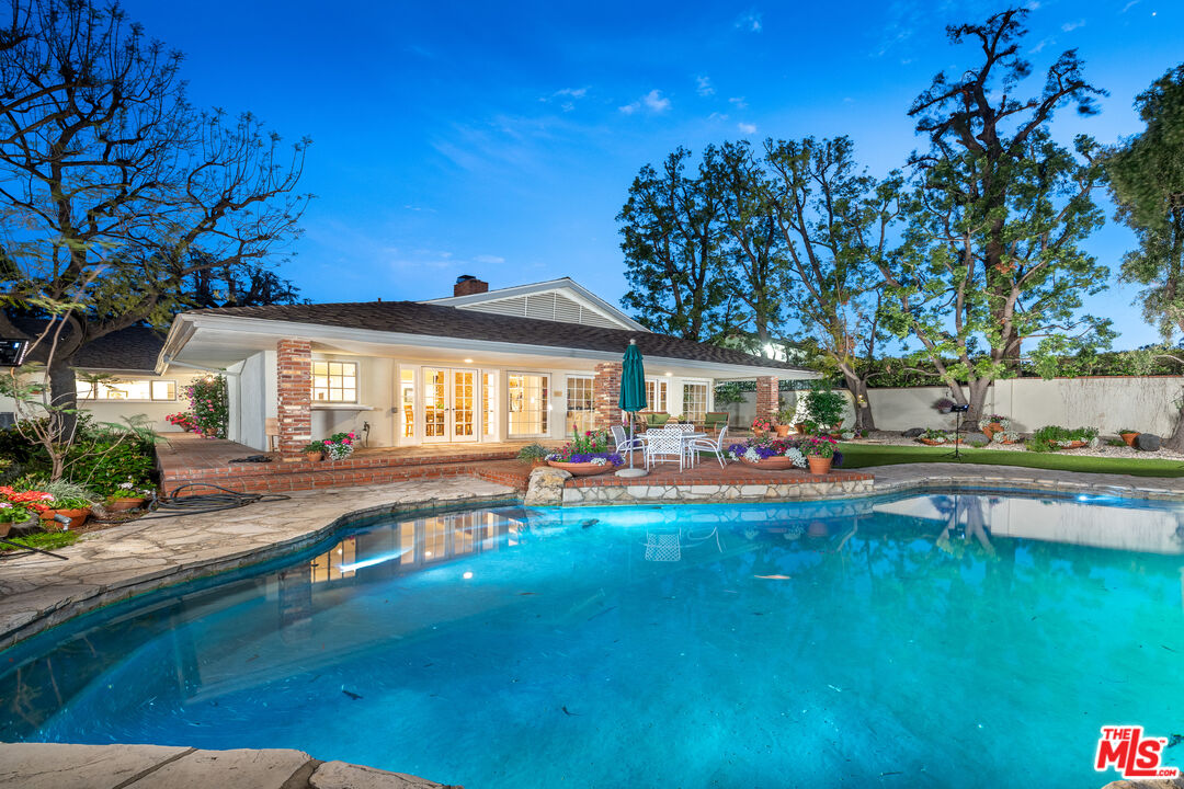 16331 Tudor Drive Encino, CA 91436 - Photo 42 of 71 a front view of a house with swimming pool having outdoor seating