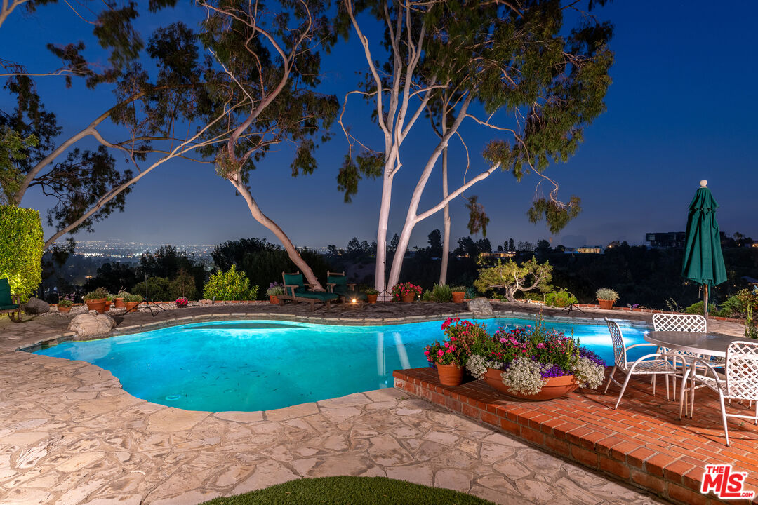 16331 Tudor Drive Encino, CA 91436 - Photo 44 of 71 a view of a chairs and table in a backyard