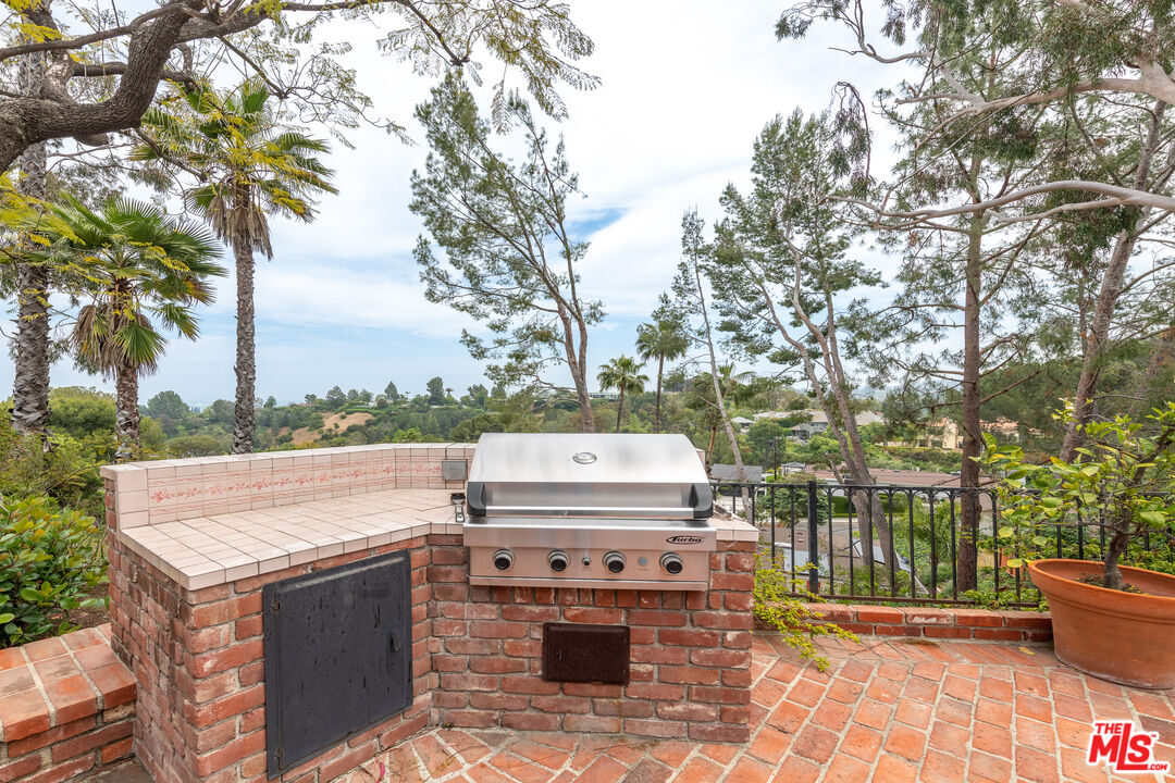16331 Tudor Drive Encino, CA 91436 - Photo 47 of 71 a view of a patio with a fireplace