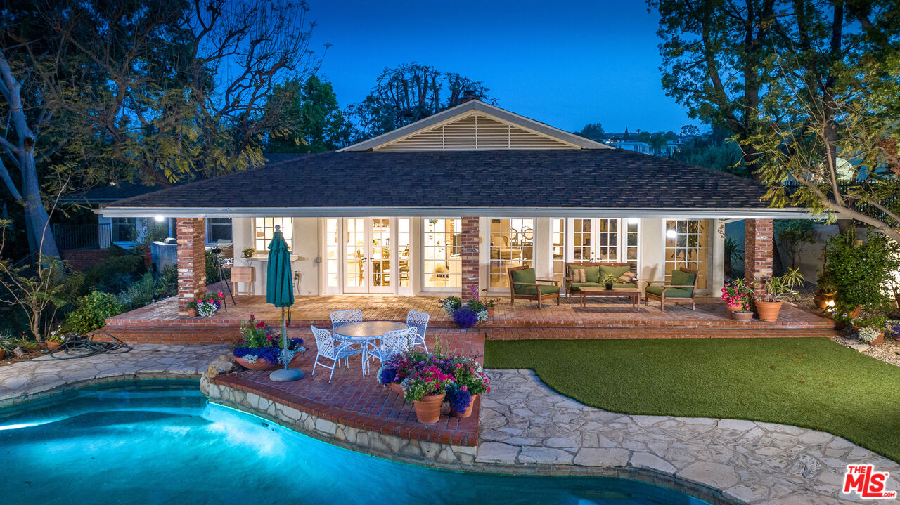 16331 Tudor Drive Encino, CA 91436 - Photo 64 of 71 a front view of a house with swimming pool having outdoor seating