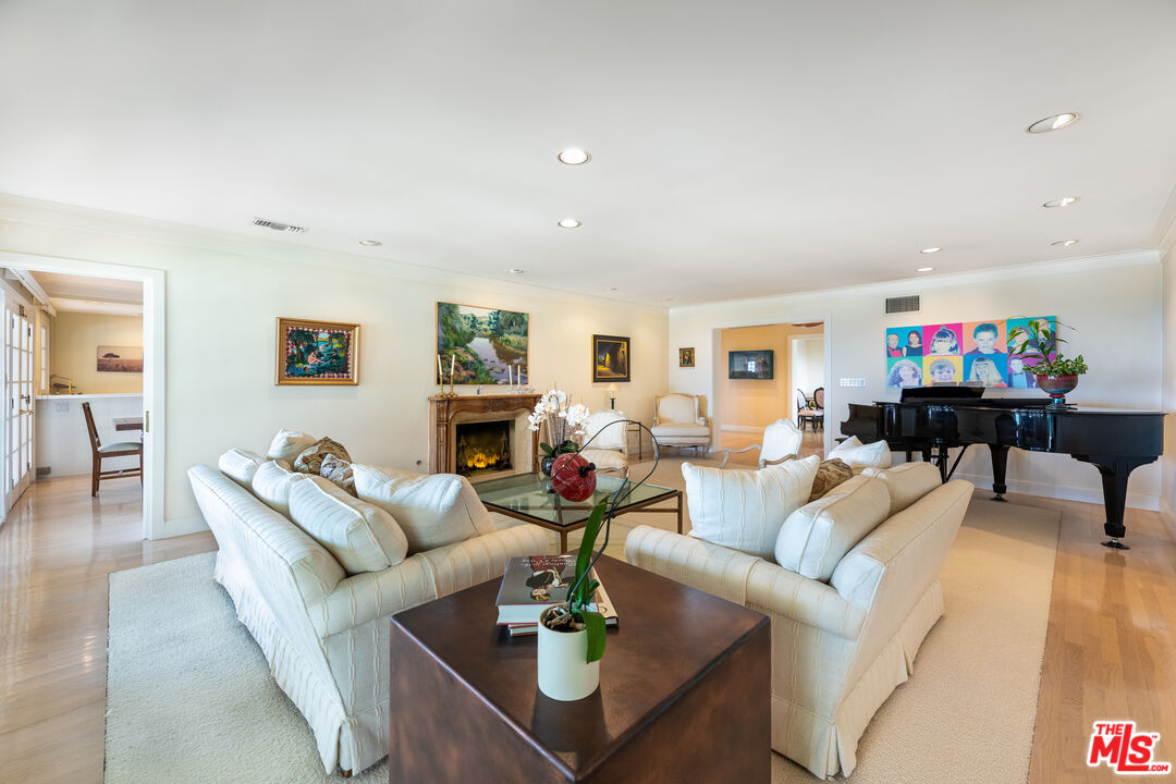 16331 Tudor Drive Encino, CA 91436 - Photo 9 of 71 a living room with fireplace furniture and a wooden floor