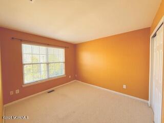 284 Brookfield Drive Jackson, NJ 08527 - Photo 14 of 17 an empty room with a empty space and a window