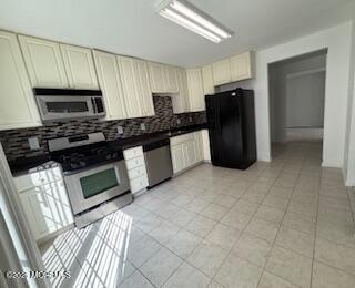 284 Brookfield Drive Jackson, NJ 08527 - Photo 7 of 17 a kitchen with granite countertop a refrigerator a stove top oven and sink