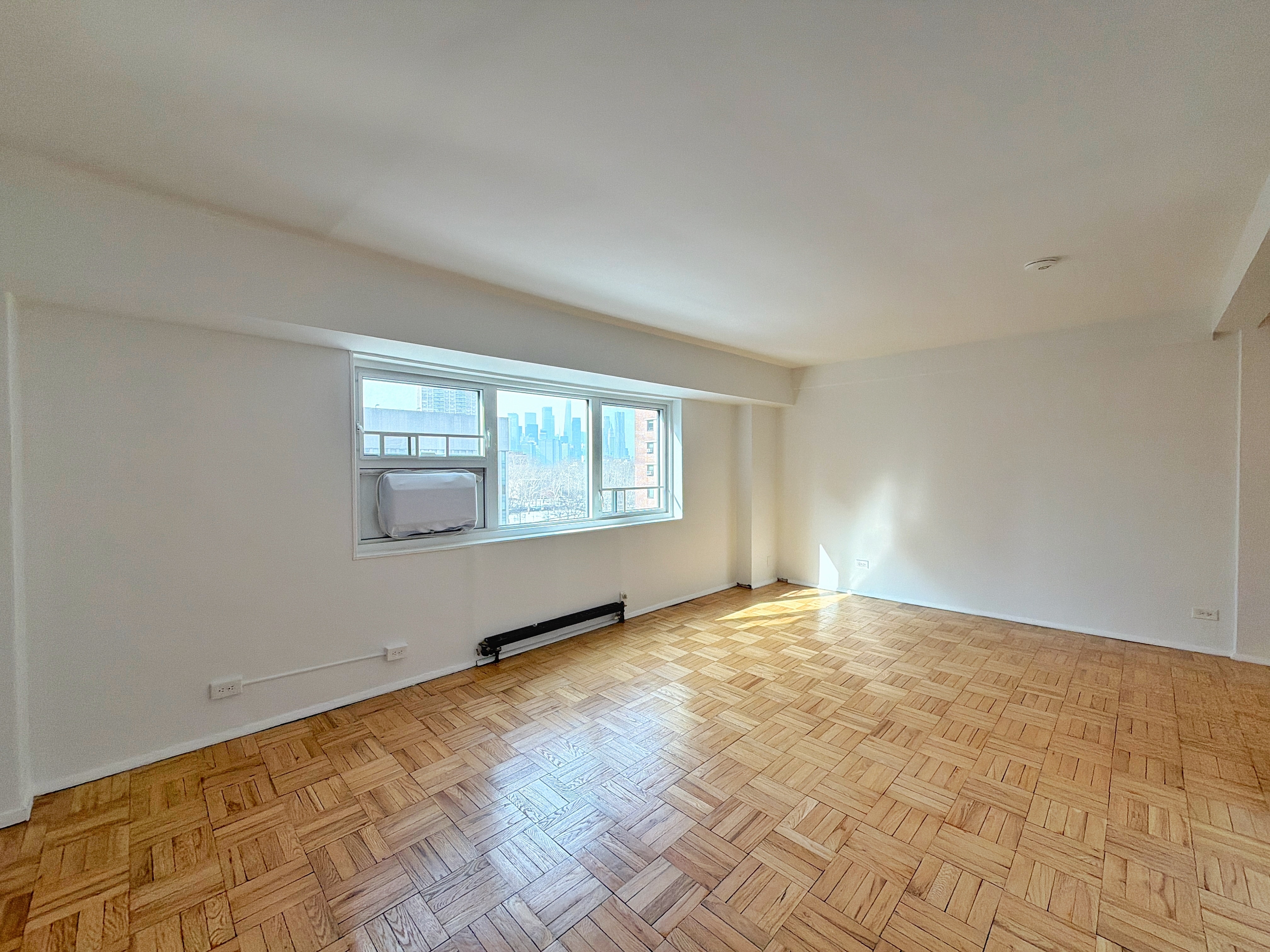 175 Adams Street, Unit 9DE Brooklyn, NY 11201 - Photo 16 of 18 a view of an empty room with a window