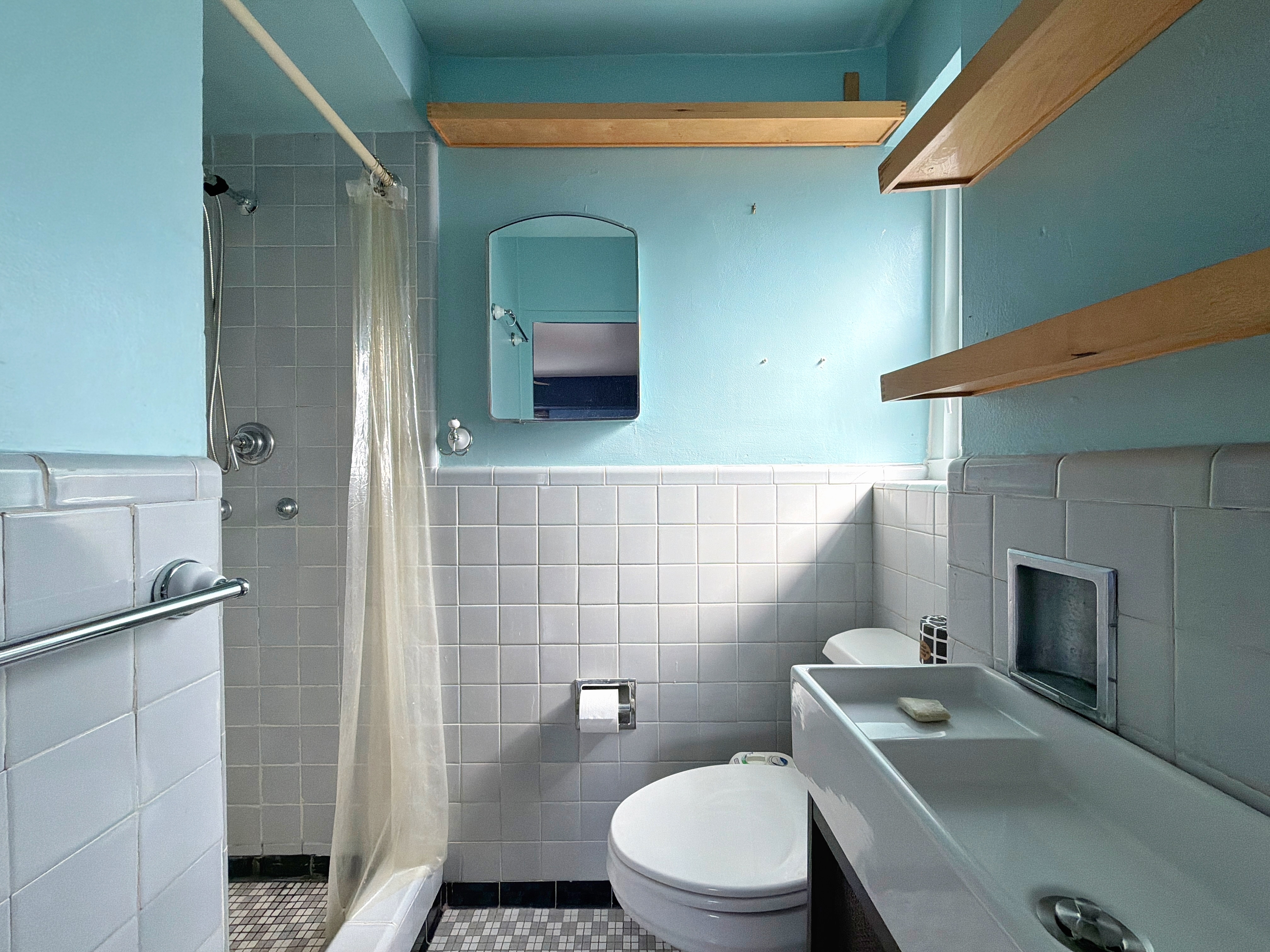 175 Adams Street, Unit 9DE Brooklyn, NY 11201 - Photo 17 of 18 a bathroom with a toilet a sink and mirror