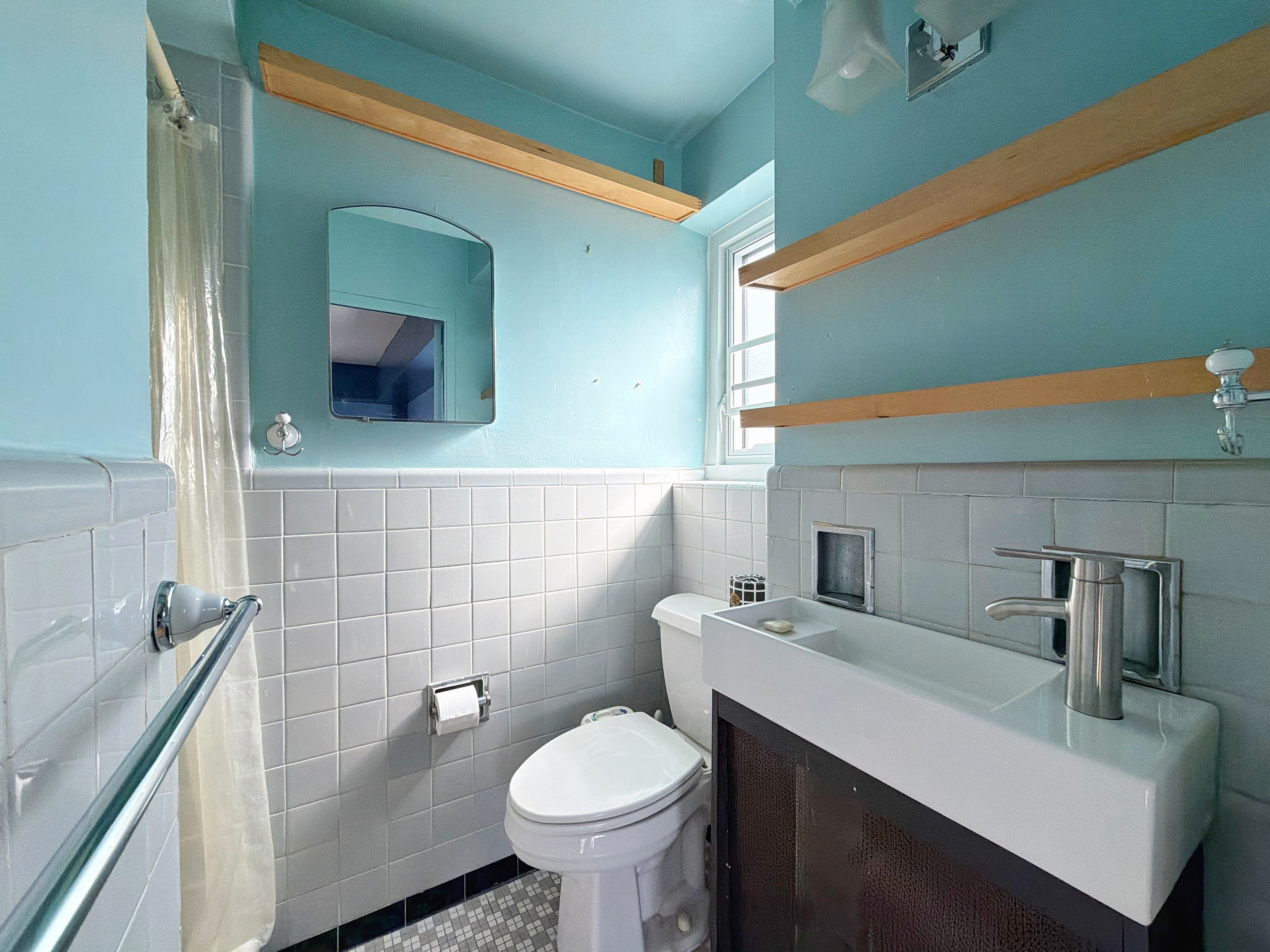 175 Adams Street, Unit 9DE Brooklyn, NY 11201 - Photo 7 of 18 a bathroom with a sink toilet and mirror