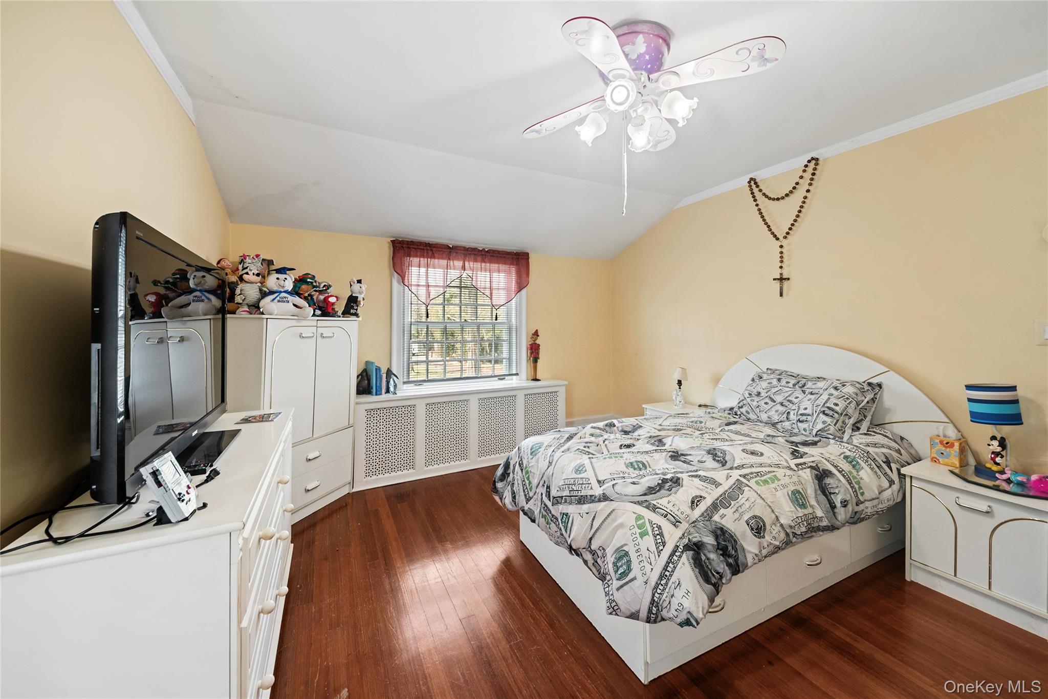 75 Chappaqua Road Briarcliff Manor, NY 10510 - Photo 17 of 50 Bedroom featuring wood-finish flooring, a window with decorative security bars, and a ceiling fan with integrated lighting