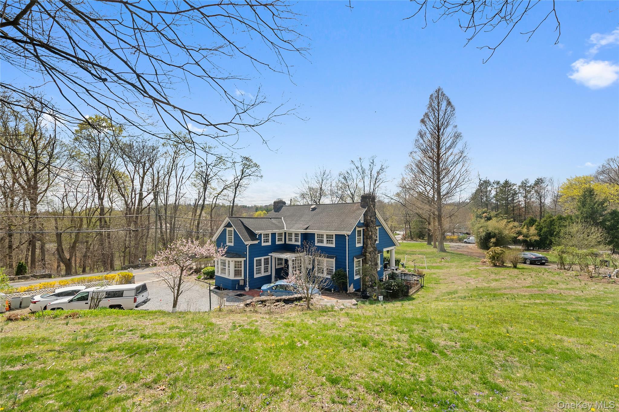 75 Chappaqua Road Briarcliff Manor, NY 10510 - Photo 2 of 50 Colonial-style residence featuring a blue exterior, white window trim, and a prominent stone chimney