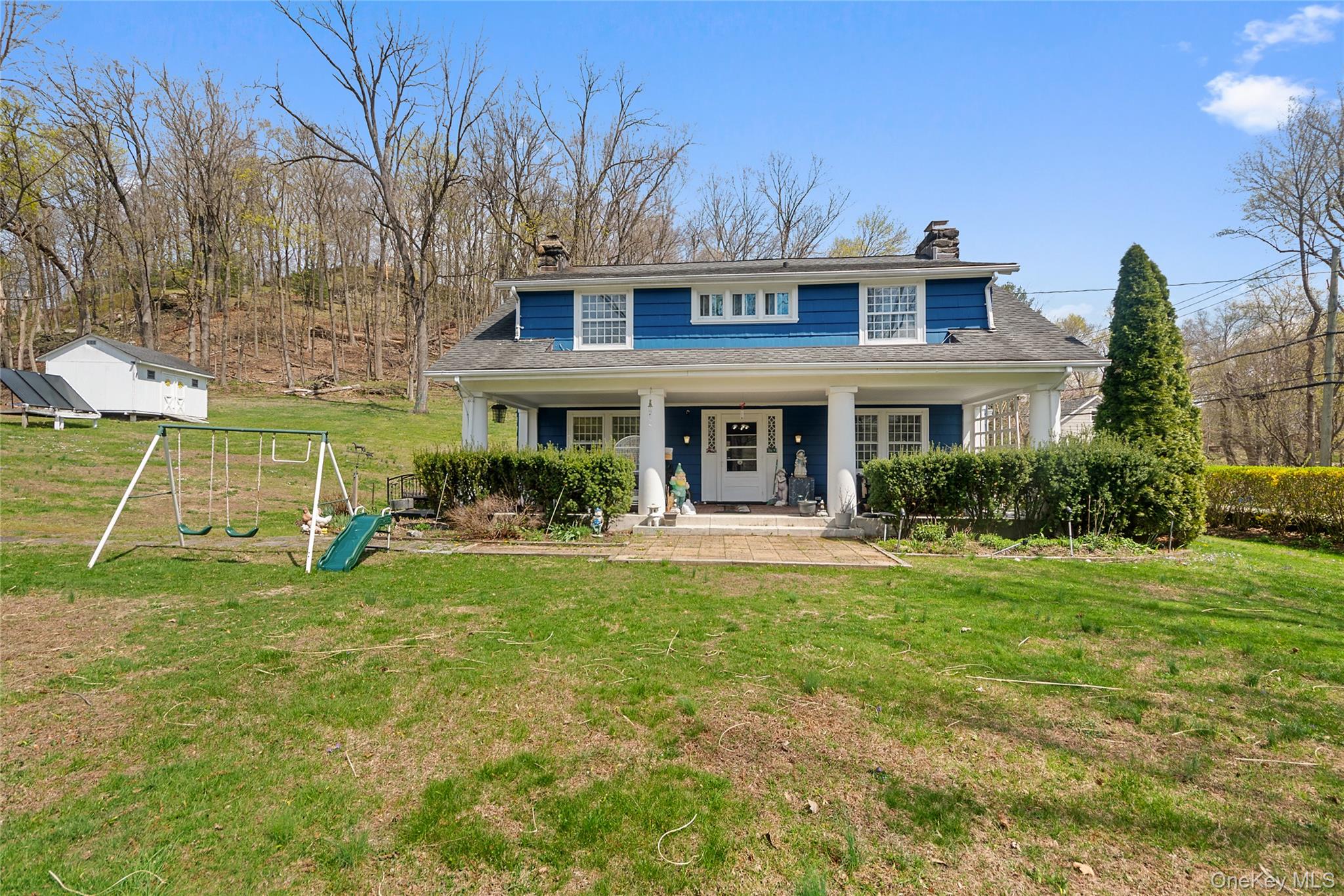 75 Chappaqua Road Briarcliff Manor, NY 10510 - Photo 34 of 50 Blue siding exterior with a covered front porch, white columns, and multiple windows