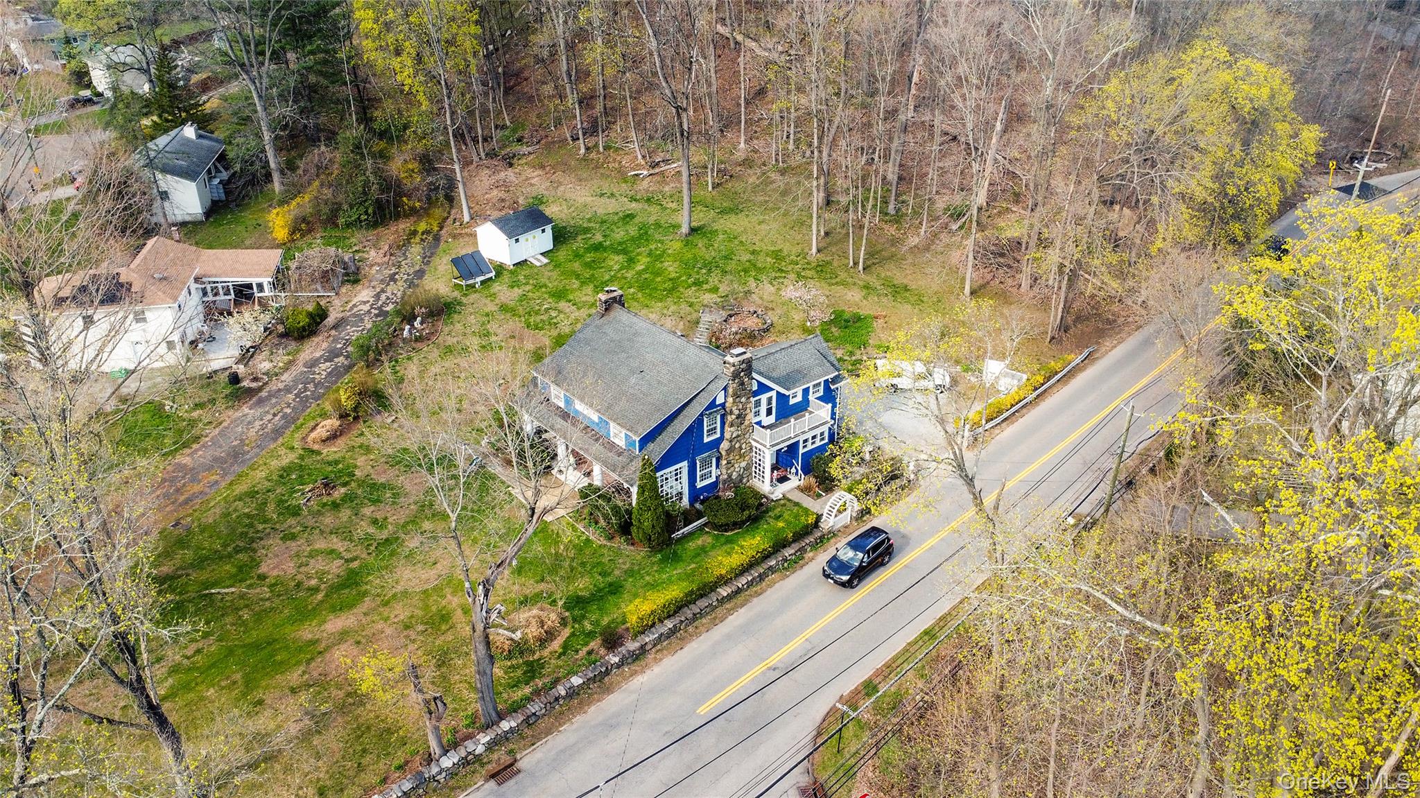 75 Chappaqua Road Briarcliff Manor, NY 10510 - Photo 36 of 50 Two-story residence featuring blue siding, white trim, and a prominent stone chimney