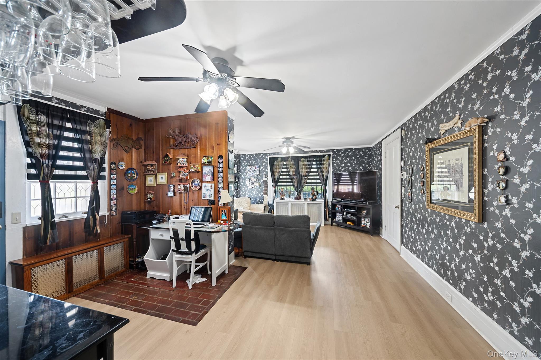 75 Chappaqua Road Briarcliff Manor, NY 10510 - Photo 4 of 50 Open-concept living area featuring light wood-finish flooring, a ceiling fan with integrated lighting, and dark floral wallpaper