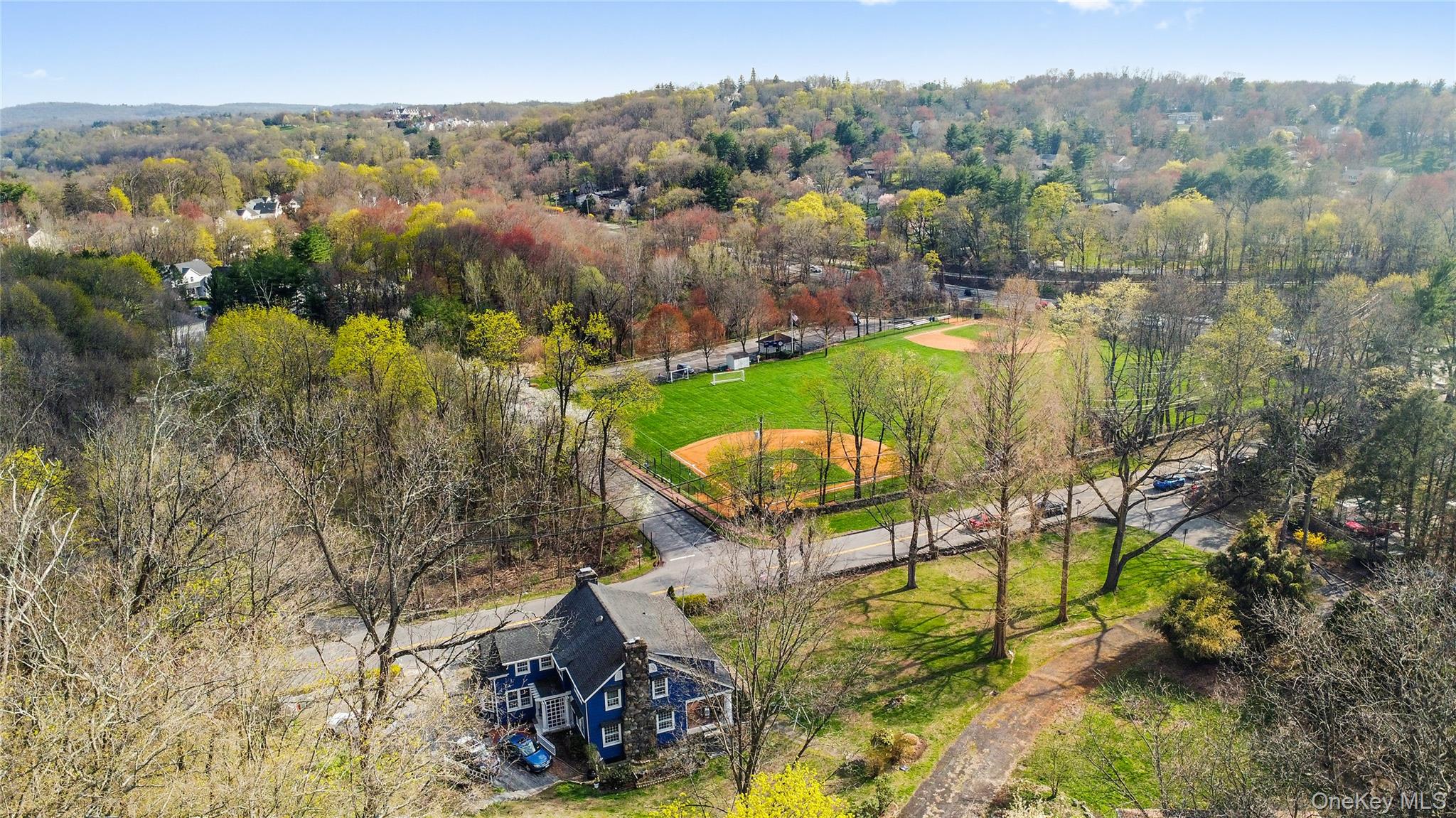 75 Chappaqua Road Briarcliff Manor, NY 10510 - Photo 41 of 50 Blue-sided residence featuring a dark roof and prominent chimney