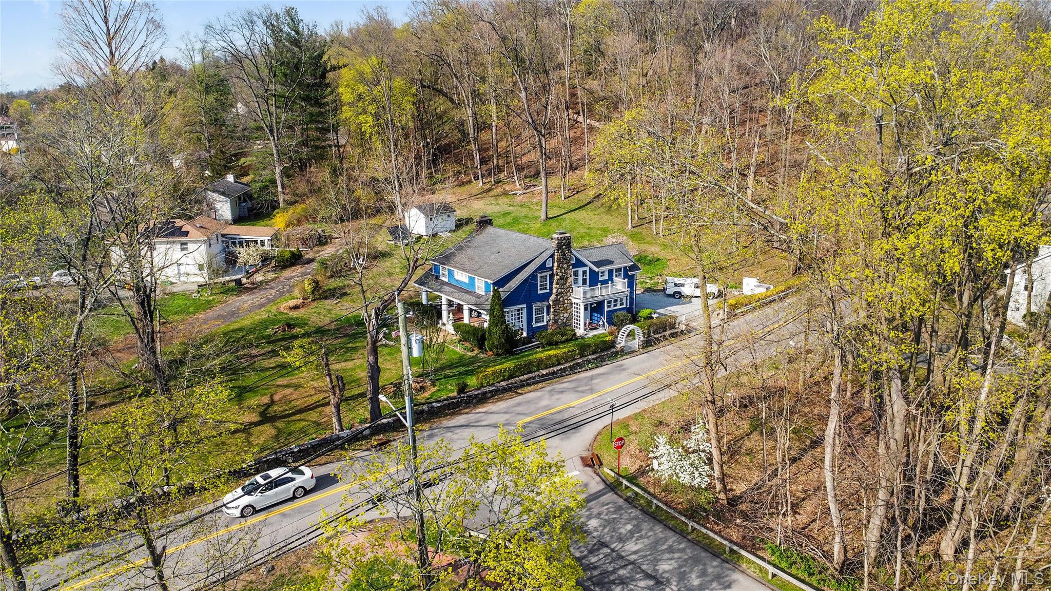 75 Chappaqua Road Briarcliff Manor, NY 10510 - Photo 43 of 50 Blue-sided residence with a prominent stone chimney, set on a sloped lot