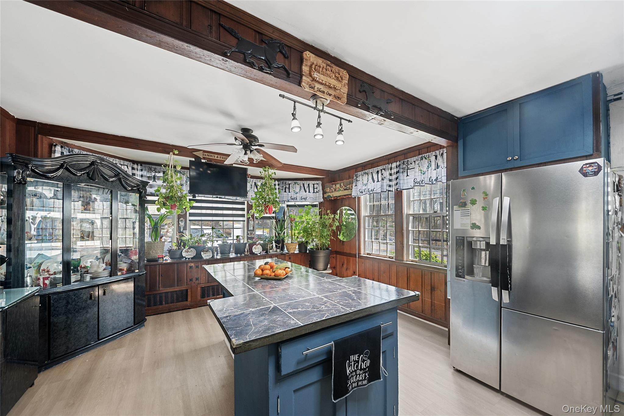 75 Chappaqua Road Briarcliff Manor, NY 10510 - Photo 5 of 50 Kitchen featuring wood-paneled walls, light wood-finish flooring, and a ceiling fan