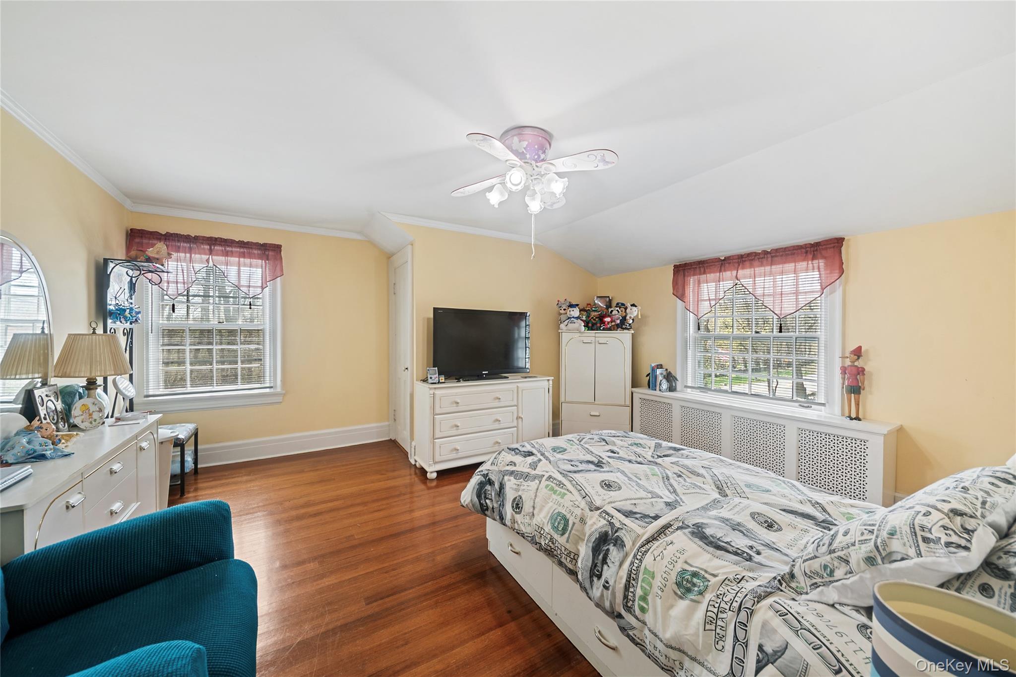 75 Chappaqua Road Briarcliff Manor, NY 10510 - Photo 10 of 50 Interior room featuring wood-finish flooring, two large windows with mullions, and a ceiling fan with integrated lighting