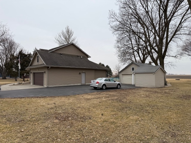 12027 Lisbon Road Newark, IL 60541 - Photo 3 of 29 a view of a house with a yard and garage
