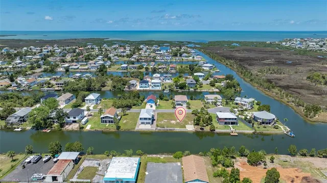 a view of a city with lawn chairs under an umbrella