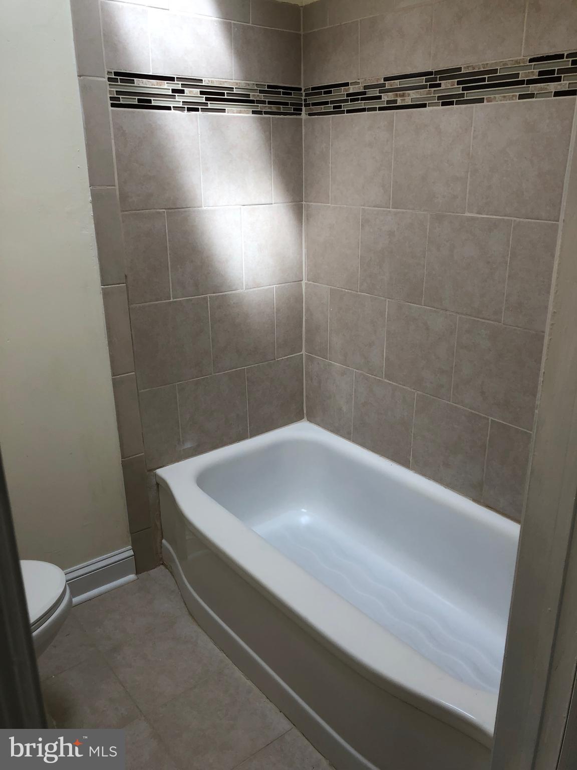 1828 Farrington Road Philadelphia, PA 19151 - Photo 13 of 24 New Ceramic Tile in Hall Bath