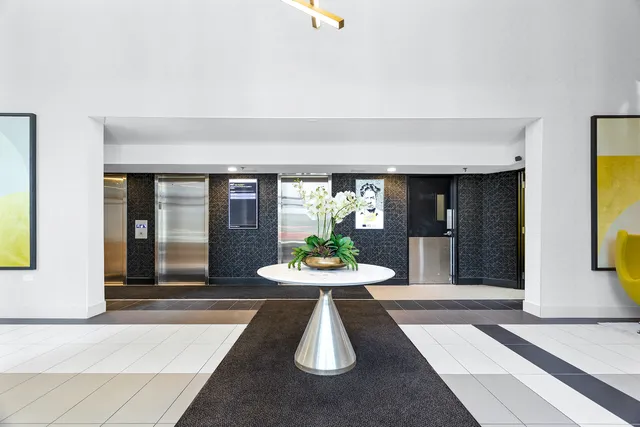 a dining room with furniture and a large window