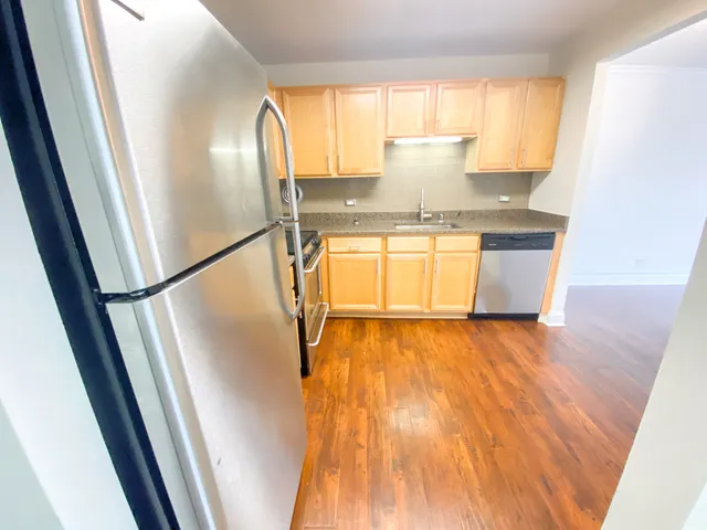 a view of a room with wooden floor and a window