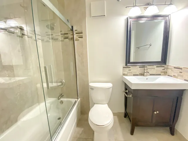 a bathroom with a sink toilet and shower