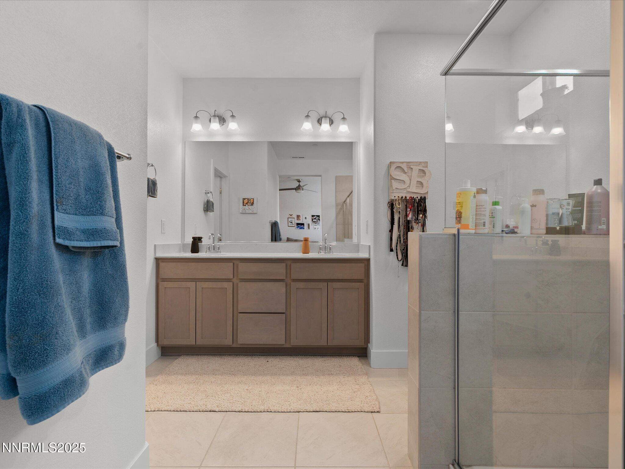 3621 Pulsar Lane, Unit 2 Carson City, NV 89705 - Photo 21 of 31 a bathroom with a double vanity sink and a mirror
