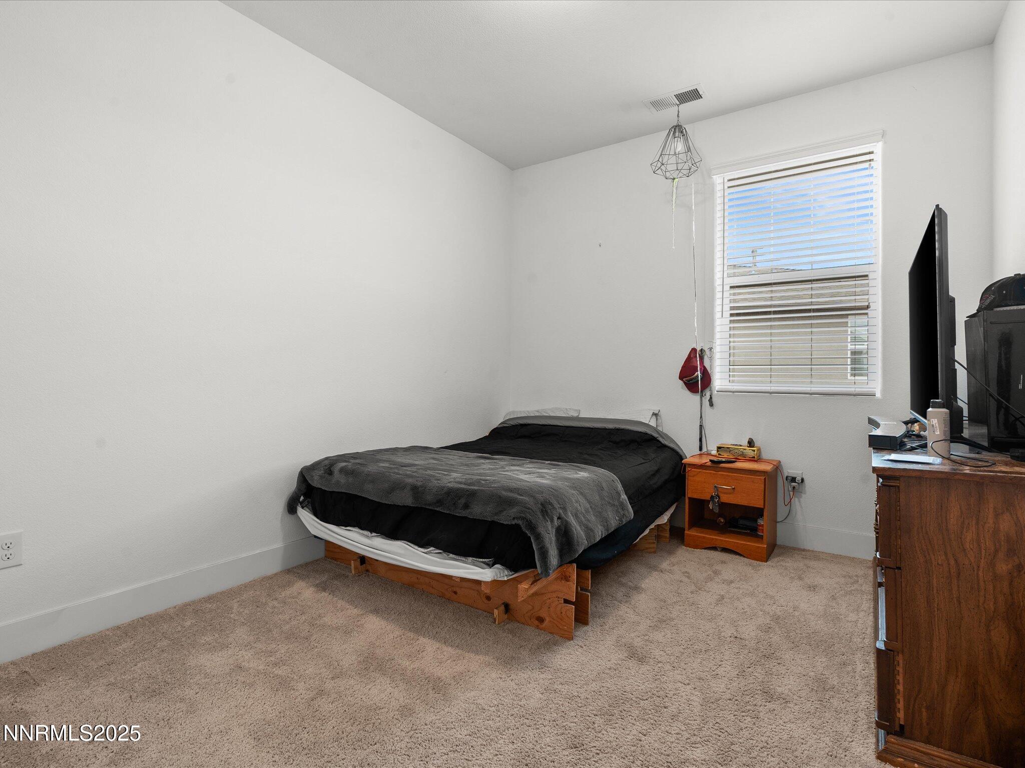 3621 Pulsar Lane, Unit 2 Carson City, NV 89705 - Photo 24 of 31 a room with a bed and a window