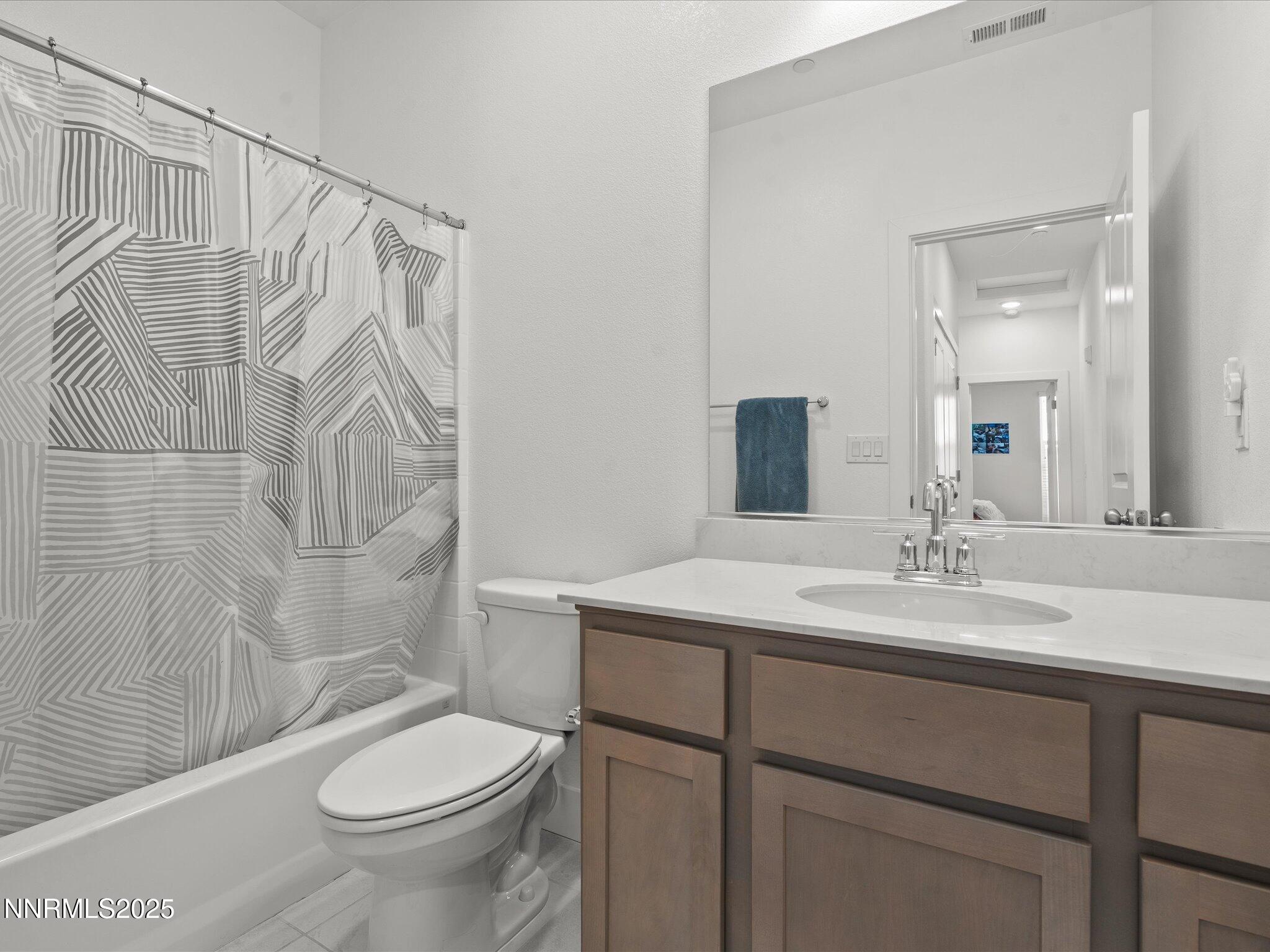 3621 Pulsar Lane, Unit 2 Carson City, NV 89705 - Photo 26 of 31 a bathroom with a sink a toilet and shower
